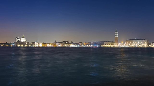 Venice Sea Grand Canal Night to Day timelapse, view of Doges Palace San Marco square and Punta della Dogana Salute Church.