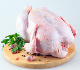 raw chicken carcass on the cutting board isolated on white background © davit85