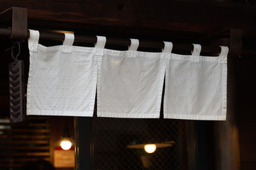 The curtain-like fabric that hangs in front of traditional Japanese restaurants and shops not only serves as a signboard, but holds a larger meaning,