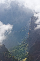 View down from mountain peak at a valley in distant