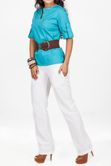 female clothes, lady dressed in elegant blue shirt and white pants in neutral background