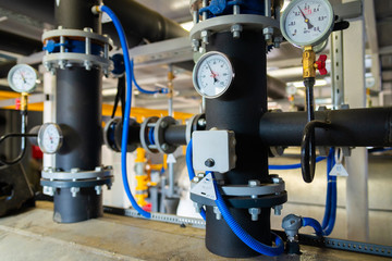 The equipment of the boiler-house, valves, tubes, pressure gauges, thermometer. Close up of...