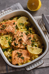 Salmon baked on oven with rice and lemon.