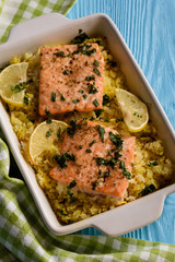 Salmon baked on oven with rice and lemon.