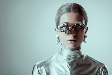 futuristic silver robot looking at camera isolated on grey, future technology concept