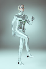 Fototapeta na wymiar full length view of futuristic cyborg walking on grey, future technology concept