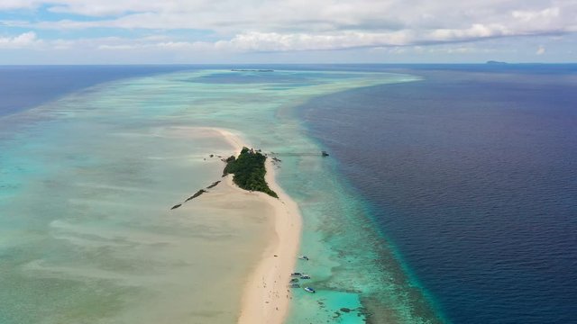 Aerial panoramic view of sandy islet Timba Timba, turquoise crystal clear waters of Celebes Sea, white sand beaches and coral reefs  - landscape panorama of Borneo island, Malaysia, Pacific Ocean