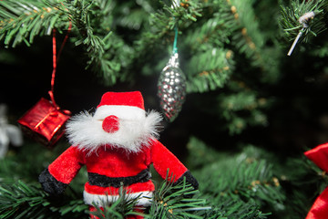 Santa Claus on a christmas tree with some shining and colorful decoration.