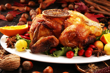 Baked turkey or chicken. The Christmas table is served with a turkey, decorated with fruits, salad and nuts. Fried chicken, table. Christmas dinner