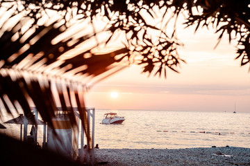 Boat off the coast at sunset