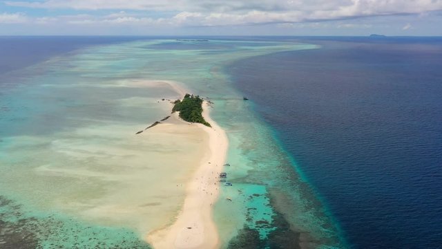 Aerial panoramic view of sandy islet Timba Timba, turquoise crystal clear waters of Celebes Sea, white sand beaches and coral reefs  - landscape panorama of Borneo island, Malaysia, Pacific Ocean