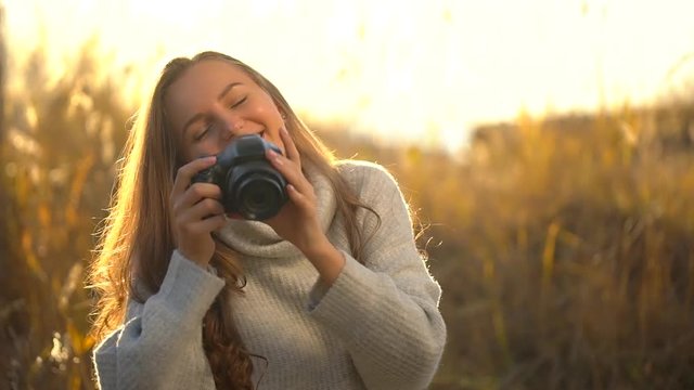 Portrait of tourist teen girl traveler female photographer woman photographing girl making photo. Photographer take picture of camera in summer nature outdoors at sunset. Travel tourism happy holidays