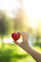Woman hands holding red heart