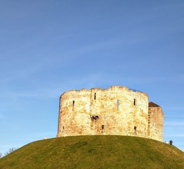 Fototapeta na wymiar Standing on top of a hill owned by English Heritage Clifford's Tower is part of the landscape of York