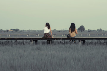 Asian people relax and take a photography on wooden bridge in th