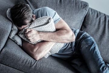 Disappointed young man covering his face