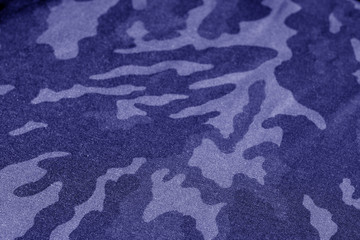 Old camouflage cloth with blur effect in blue tone. © pavelalexeev