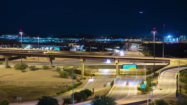 Phoenix AZ Night Timelapse Over Highway 202 East to Tempe and Mesa with Streaking Lights from Driving Vehicles and Arriving Jet Airliners in a Blue Evening Sky