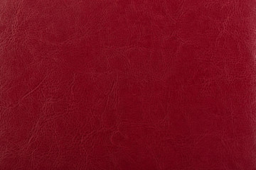 Dark red leather surface as a background, leather texture. Skin 