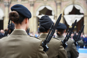 Detail with uniformed women standing during the military ceremony in Bologna, Italy. In the...