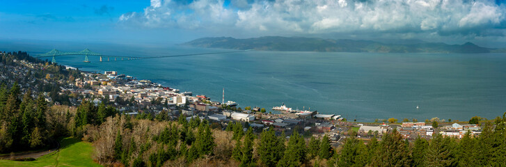 Historic Astoria, Oregon, USA. This view of the Astoria skyline is from the Astoria Column on a hill above the city featuring the beautiful Columbia River and the Astoria–Megler Bridge.
