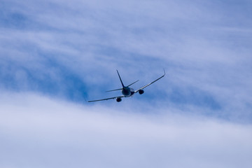 Plane taking off landing over blue sky
