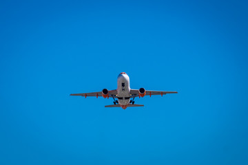 Plane taking off landing over blue sky