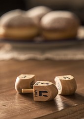 Hanukkah Celebration Concept-dreidels on the Rustic table with D
