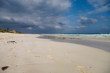White sand  beach and waves on the coast of the Caribbean Sea, Mexico. Riviera Maya