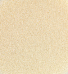 Fototapeta na wymiar Yellow sponge texture background, close up view of a cosmetic sponge or pad for facial make up