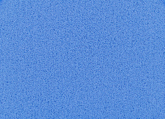 Blue sponge texture background, close up view of a cosmetic sponge or pad for facial make up