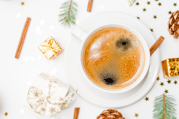 Top view of a cup of coffee, isolate on white with Christmas toys, pine cones, cinnamon, and New Year decor