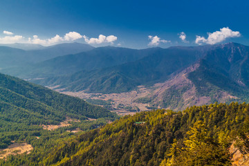 View over the mountains in Bhutan on the way to Taktshang Goemba(Tiger's Nest Monastery), the most famous Monastery in Bhutan, in a mountain cliff.