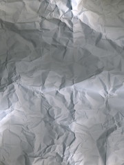 The texture of a white crumpled sheet of paper.