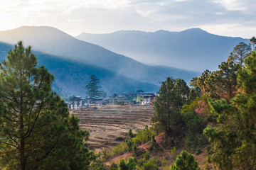 Terraced rice field with rural houses in Bhutan. Bhutan is a small country in the Himalayas between the Tibet Autonomous Region of China and India.