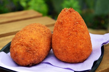 a couple of arancini, typical sicilian street food made with rice