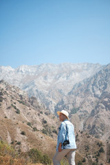 Naklejka na ściany i meble Photographer tourist with camera while standing on the mountain
