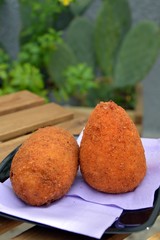 a couple of arancini, typical sicilian street food made with rice
