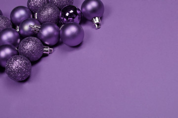 Christmas baubles on purple background.