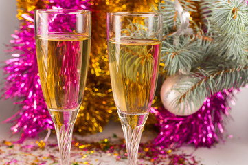 Celebration of New year eve. Glasses with champagne and pink and gold garland.