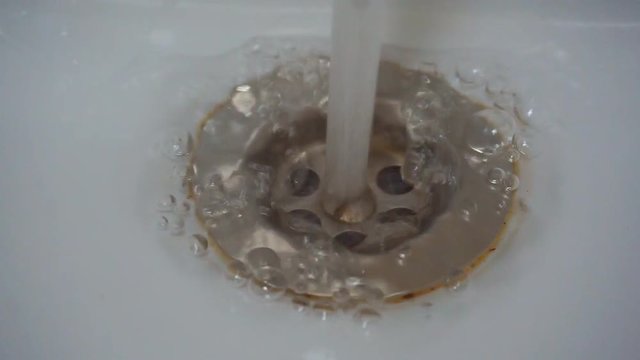 Water flows out of the tap. Sink. 1920X1080 Full Hd.