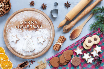 Ingredients for Christmas and Advent Baking, gingerbread and cookies on concrete light blue table. Top view, close-up.  Christmas, New Year concept