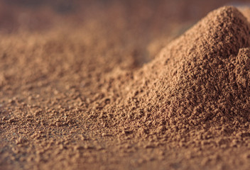 dark chocolate, cocoa solids and cocoa powder over wooden background