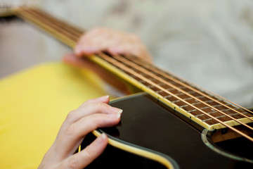 Woman holding an acoustic bass guitar