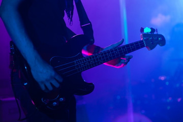 Fototapeta na wymiar Live rock music background, bass guitar player