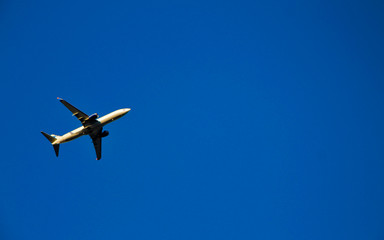 Airplane flying against blue sky