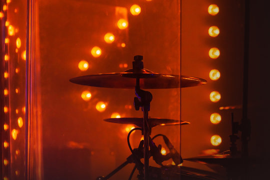 Drum set  with cymbals in red stage lights