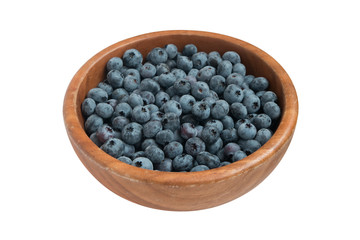 bilberry in wooden bowl. isolated.