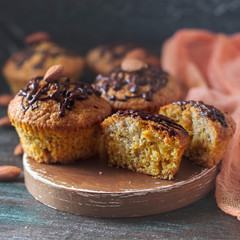 Muffins, cakes with almond nuts on a dark background. Copy space.