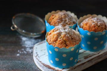 Muffins, cakes with almond nuts on a dark background. Copy space.